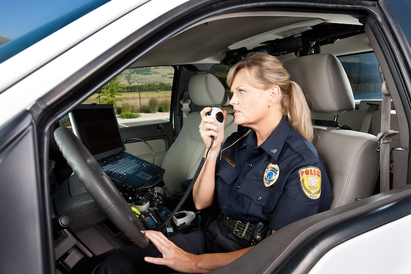 officier using technology in car - toughbook